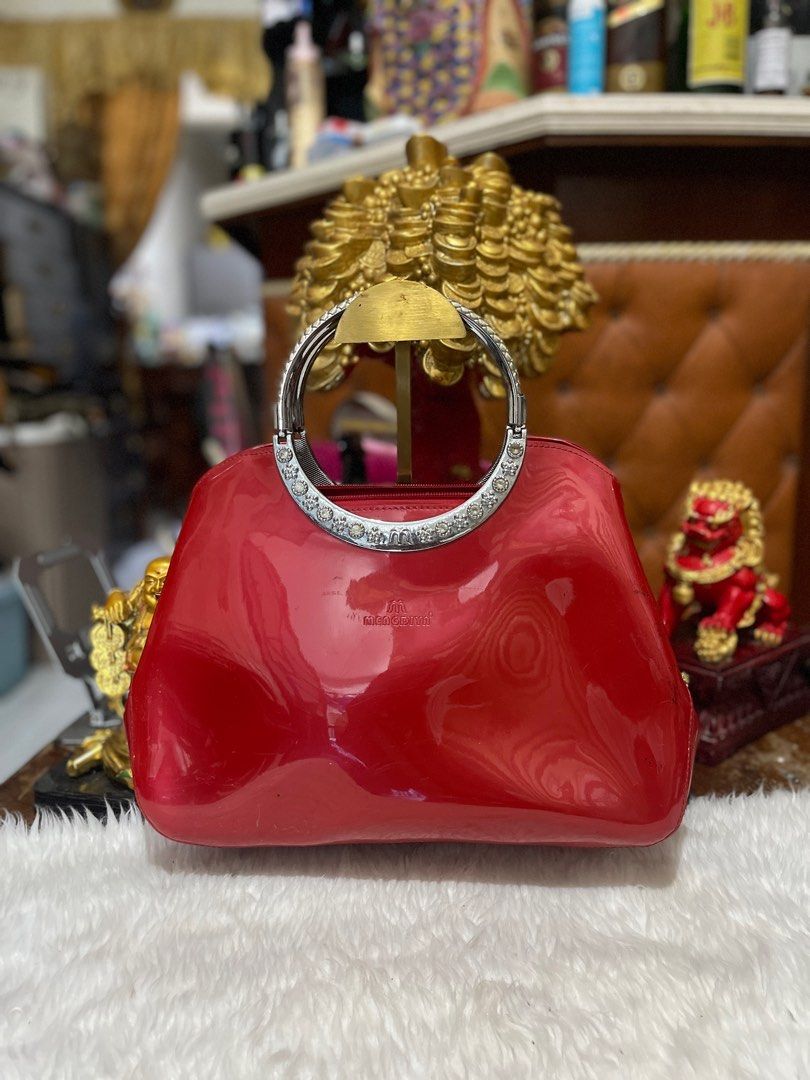 Red Patent Leather Handbag (Category: Luxury Bags & Wallets) located in Calamba. Submitted by angelspetdogs (Listing ID 1399027541, Image 1). Description: - Red patent leather handbag - Silver handle with decorative elements - Glossy finish - Structured shape - Subtle logo detail - Perfect for various occasions.