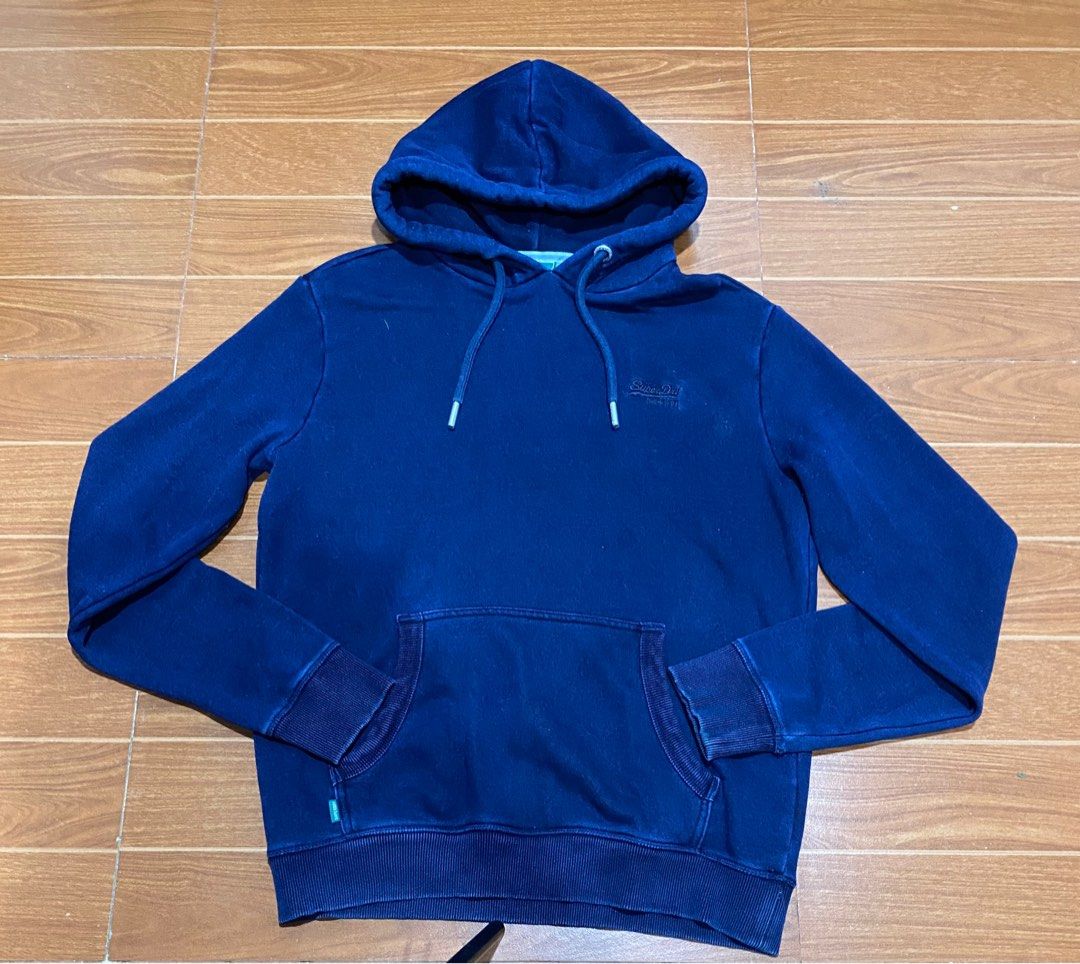 Superdry Navy Blue Hoodie - Size L (Category: Coats, Jackets and Outerwear) located in Quezon City. Submitted by ez_pick (Listing ID 1399036320, Image 1). Description: - Superdry hoodie in navy blue - Size: L - Features a front pocket - Hood with drawstrings - Embroidered Superdry logo on the chest - Ribbed cuffs and hem - Made in China.