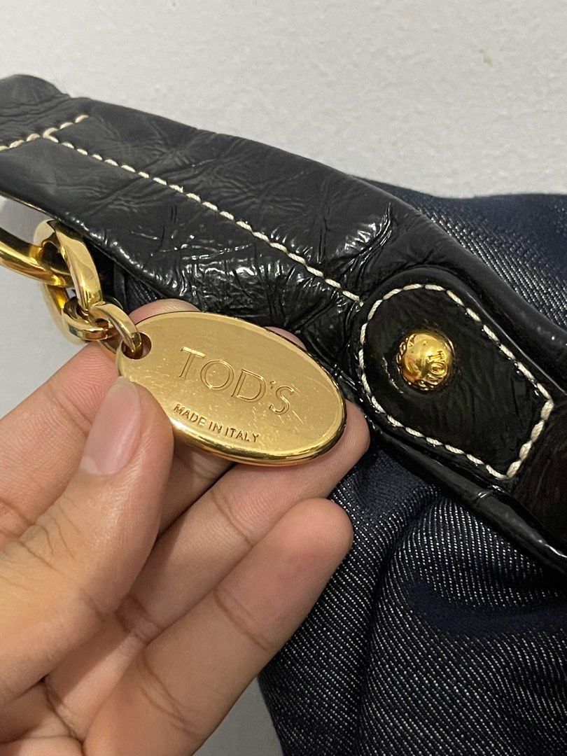 (Authentic) Tod's Denim Hobo Bag (Category: Luxury Bags & Wallets) located in Manila. Submitted by hilligna (Listing ID 1398998344, Image 3). Description: Authentic Tod's hobo bag. Denim exterior with black leather accents, gold-tone hardware, and multiple zippered pockets. Includes Tod's charm and logo zipper pull. Made in Italy. Paayos nyo nlng po zipper di nmn po papalitan ng zipper ayusin lng sa mall Authentic TOD’s Denim Bag I bought it in U