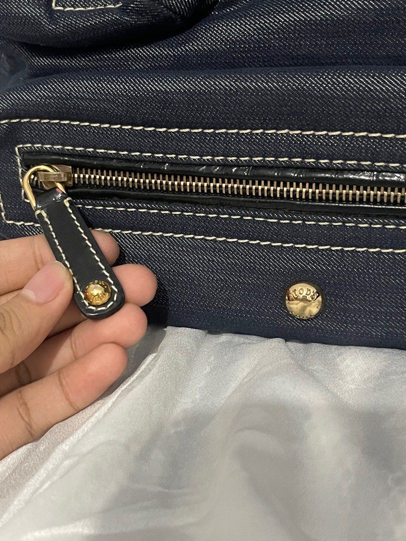 (Authentic) Tod's Denim Hobo Bag (Category: Luxury Bags & Wallets) located in Manila. Submitted by hilligna (Listing ID 1398998344, Image 2). Description: Authentic Tod's hobo bag. Denim exterior with black leather accents, gold-tone hardware, and multiple zippered pockets. Includes Tod's charm and logo zipper pull. Made in Italy. Paayos nyo nlng po zipper di nmn po papalitan ng zipper ayusin lng sa mall Authentic TOD’s Denim Bag I bought it in U