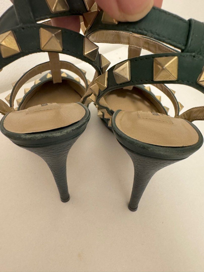 Valentino Garavani Rockstud Heels (Category: Heels) located in Taguig. Submitted by ara_gee (Listing ID 1398981166, Image 2). Description: - Valentino Garavani Rockstud heels - Color: Dark Green - Size: 36.5 - Pointed toe design - Signature gold-tone pyramid studs - T-strap and ankle strap with buckle closure - Valentino Garavani logo on insole - Authentic - No inclusion that’s why selling low -Item in really good condition - Slightly negotiable.