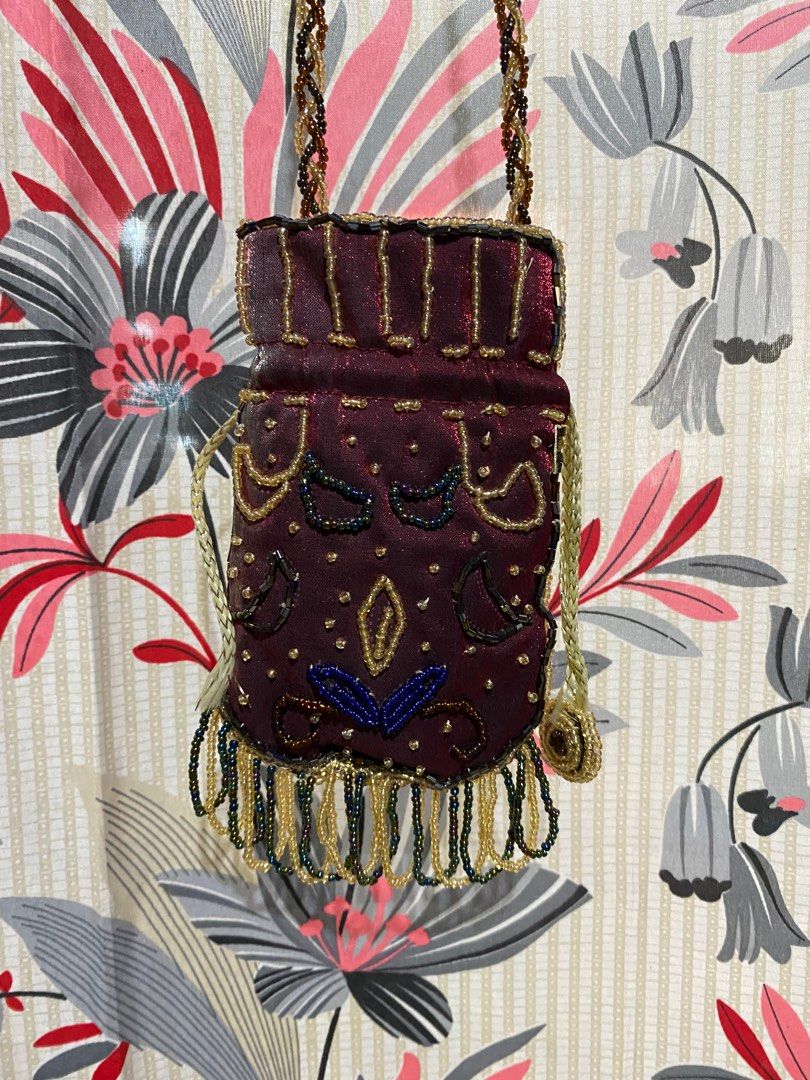 VINTAGE BEADED HANDBAG WITH SHOULDER STRAP (Category: Shoulder Bags) located in Lucena. Submitted by ojfinds (Listing ID 1398872699, Image 2). Description: ‼️FOR SALE‼️ VINTAGE BEADED HANDBAG WITH SHOULDER STRAP Colors : Burgundy, gold, and blue Braided shoulder strap Beaded fringe detail Satin-like material Matching burgundy interior Unique and stylish accessory Good condition.