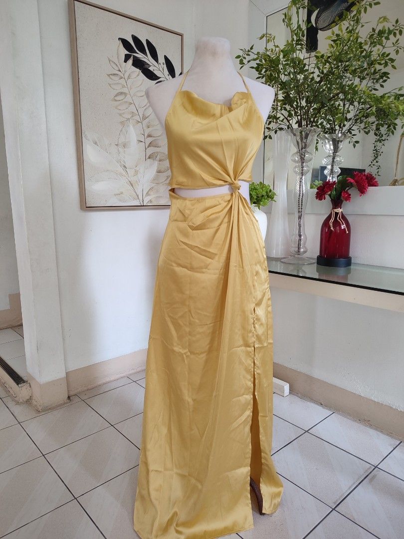 Yellow Halter Cutout Maxi Dress (Category: Dresses) located in Navotas City. Submitted by ivyyy21 (Listing ID 1398929207, Image 1). Description: small to medium - Elegant yellow maxi dress - Halter neckline with cutout detail - Flowing skirt with side slit - Crafted from a shiny, satin-like fabric - Stylish tie-back closure - Perfect for special occasions.