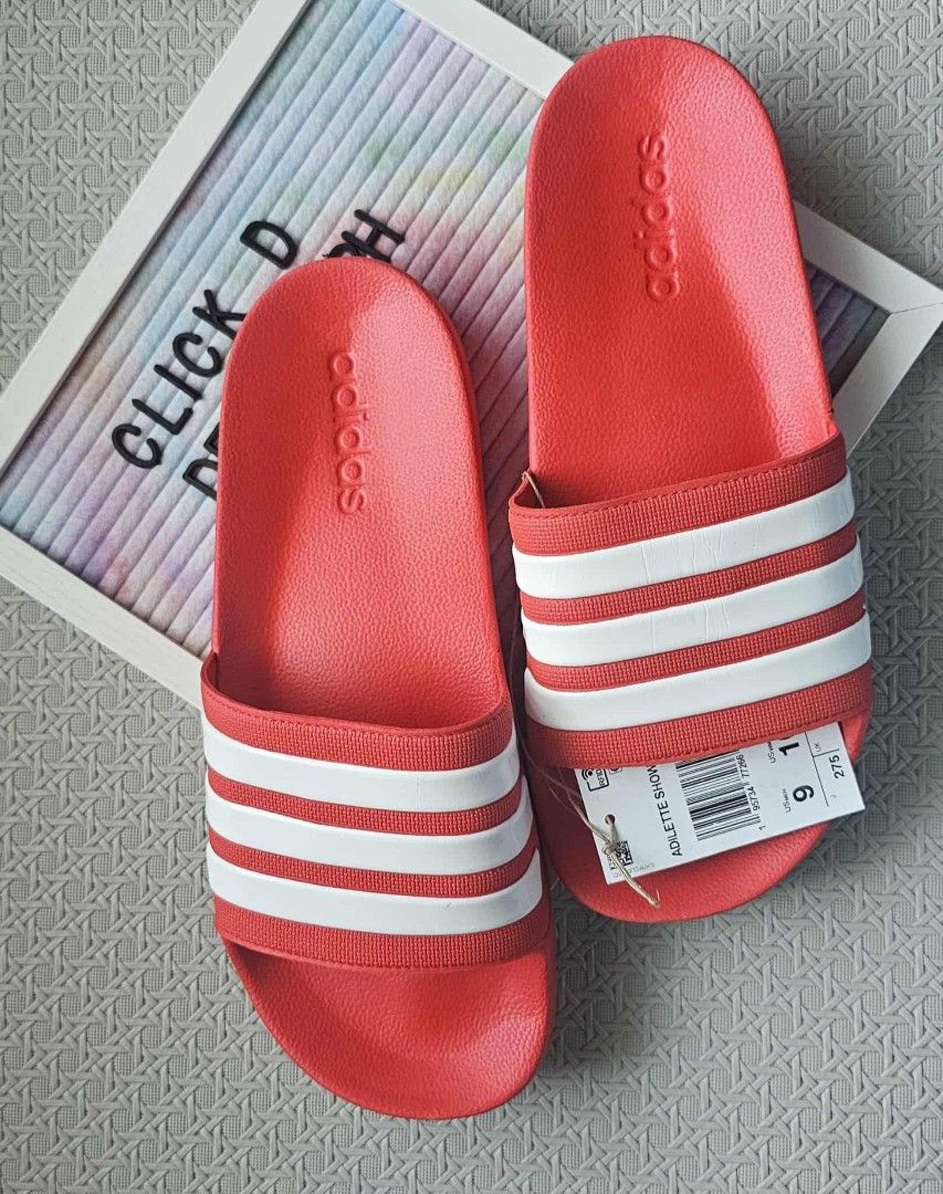 Adidas Adilette Shower Slides - Red (Category: Slippers & Slides) located in Malolos. Submitted by les0802 (Listing ID 1399116836, Image 1). Description: - Adidas Adilette Shower Slides - Color: Red with white stripes - Features Adidas logo - Size: US 9M/ 10W .
