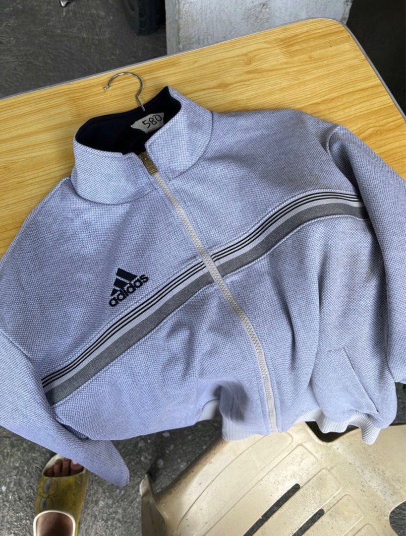 Adidas Track Jacket (Category: Coats, Jackets and Outerwear) located in Pasig City. Submitted by jijithepusa (Listing ID 1399239882, Image 2). Description: Adidas Descente Track Jacket (Gray) Length - 25.5 Width - 21 - Gray Adidas track jacket - Full zip closure - Adidas logo on chest - Iconic stripes on sleeves - Two front pockets - Ribbed hem and cuffs - High collar.
