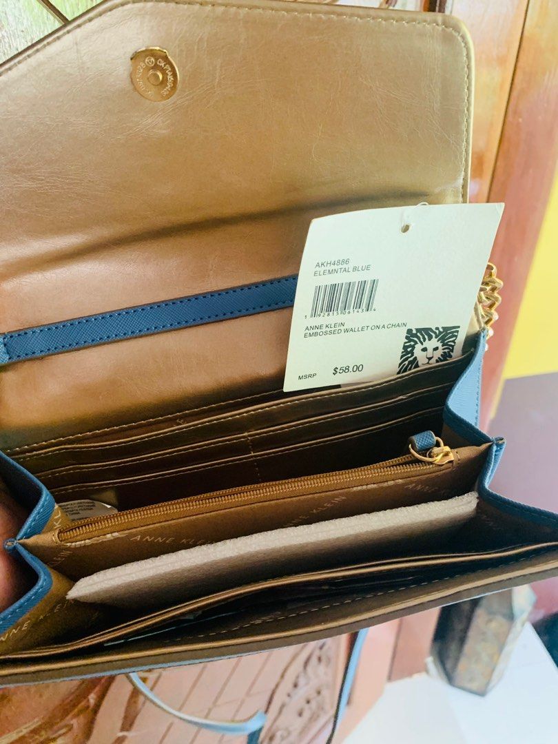 Anne Klein Embossed Wallet on Chain (Category: Luxury Bags & Wallets) located in Sarrat. Submitted by alohas_wagwagan (Listing ID 1399191696, Image 3). Description: - Anne Klein wallet on chain - Stylish embossed design - Elegant blue color - Features a chain strap - Secure magnetic closure - Interior with multiple card slots - Includes a zippered compartment - Original tag shows MSRP $58.