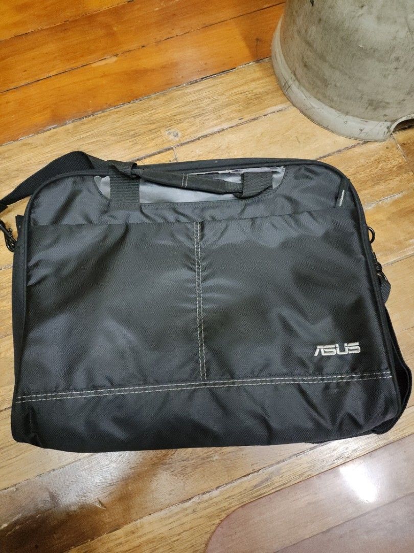 ASUS Laptop Bag (Category: Laptop Bags & Sleeves) located in Manila. Submitted by seepeeaylohyer (Listing ID 1399105510, Image 1). Description: - Black ASUS laptop bag - Main compartment and side pocket - Includes handle and shoulder strap - ASUS logo on front - Made of durable, water-resistant material.