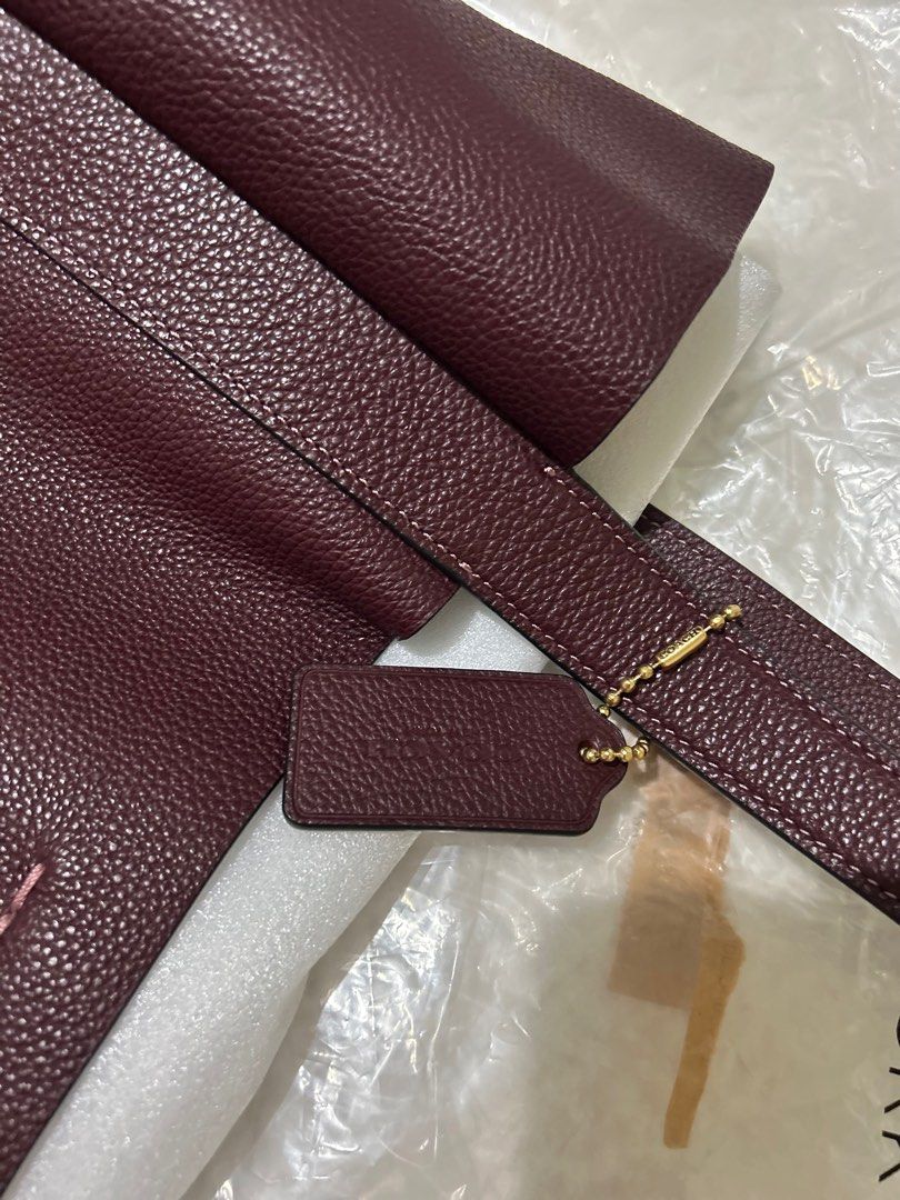 Coach Hadley Tote Bag in Merlot color (Category: Tote Bags) located in Marikina City. Submitted by decluttering.matters (Listing ID 1399240365, Image 2). Description: Coach Hadley Tote Bag in Merlot Color (like Maroon) 12.5" x 12.5" x 5.25" Inside zip pocket. Magnetic snap closure. Used twice. With polybag and paperbag. This is a good everyday office bag where your laptop and other stuff fits well. Since it is Coach, maganda talaga quality, very 