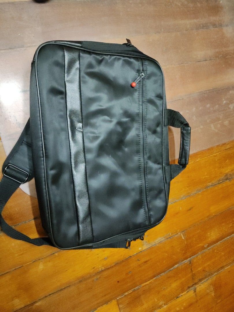 Dicota Black Laptop Bag with Shoulder Strap (Category: Laptop Bags & Sleeves) located in Manila. Submitted by seepeeaylohyer (Listing ID 1399109967, Image 1). Description: - Black laptop bag - Handle and detachable shoulder strap - Front pocket with red zipper - Padded interior - Leather-like accent - Durable and water-resistant.