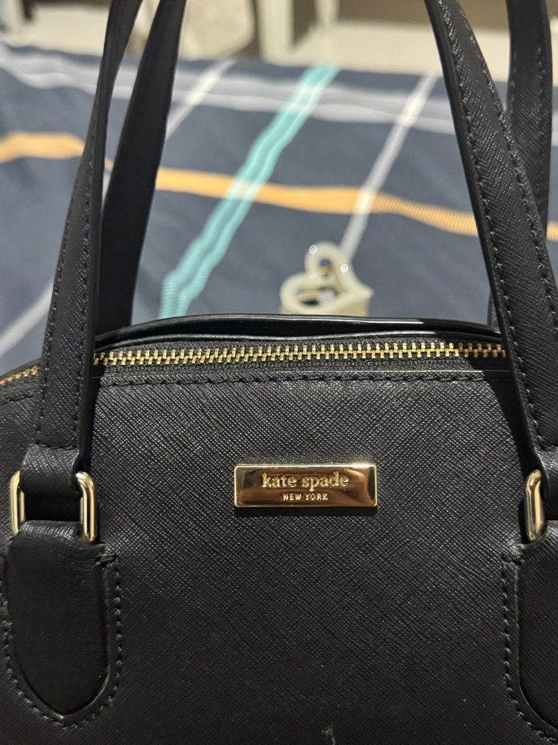 Kate Spade Black Handbag (Category: Luxury Bags & Wallets) located in Manila. Submitted by fiercestorm-45b0 (Listing ID 1399212334, Image 2). Description: - Authentic Kate Spade handbag: no Sling - Classic black color - Elegant gold-tone hardware - Secure top zipper closure - Comfortable dual top handles - Interior features signature Kate Spade fabric lining - Iconic gold Kate Spade logo on the front.