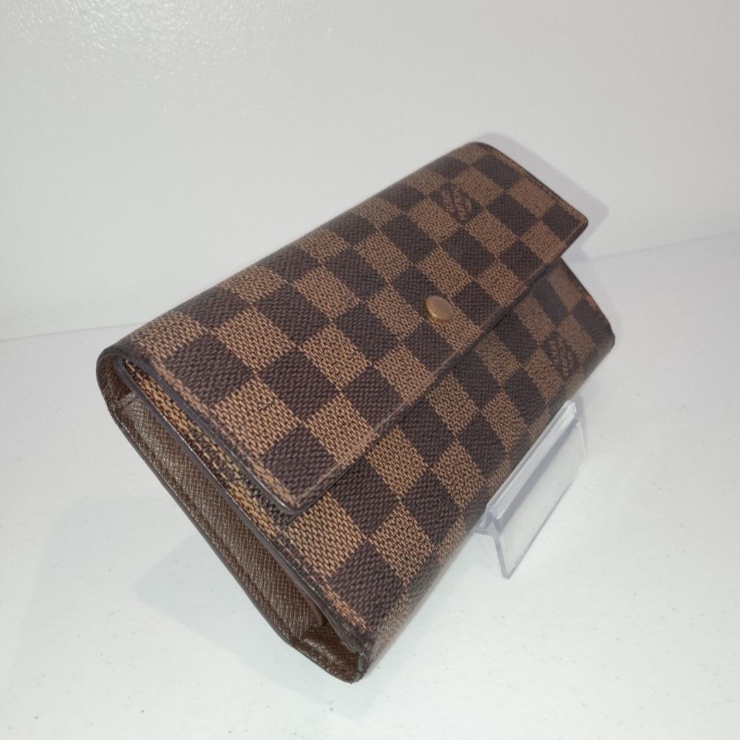 Louis Vuitton Damier Ebene Wallet (Category: Luxury Bags & Wallets) located in Mandaue City. Submitted by tokyotrend03524 (Listing ID 1399105068, Image 2). Description: Authentic Louis Vuitton Damier Ebene wallet. Features the iconic checkered pattern and a snap closure. The interior has multiple compartments for cards and cash. A classic and stylish accessory..