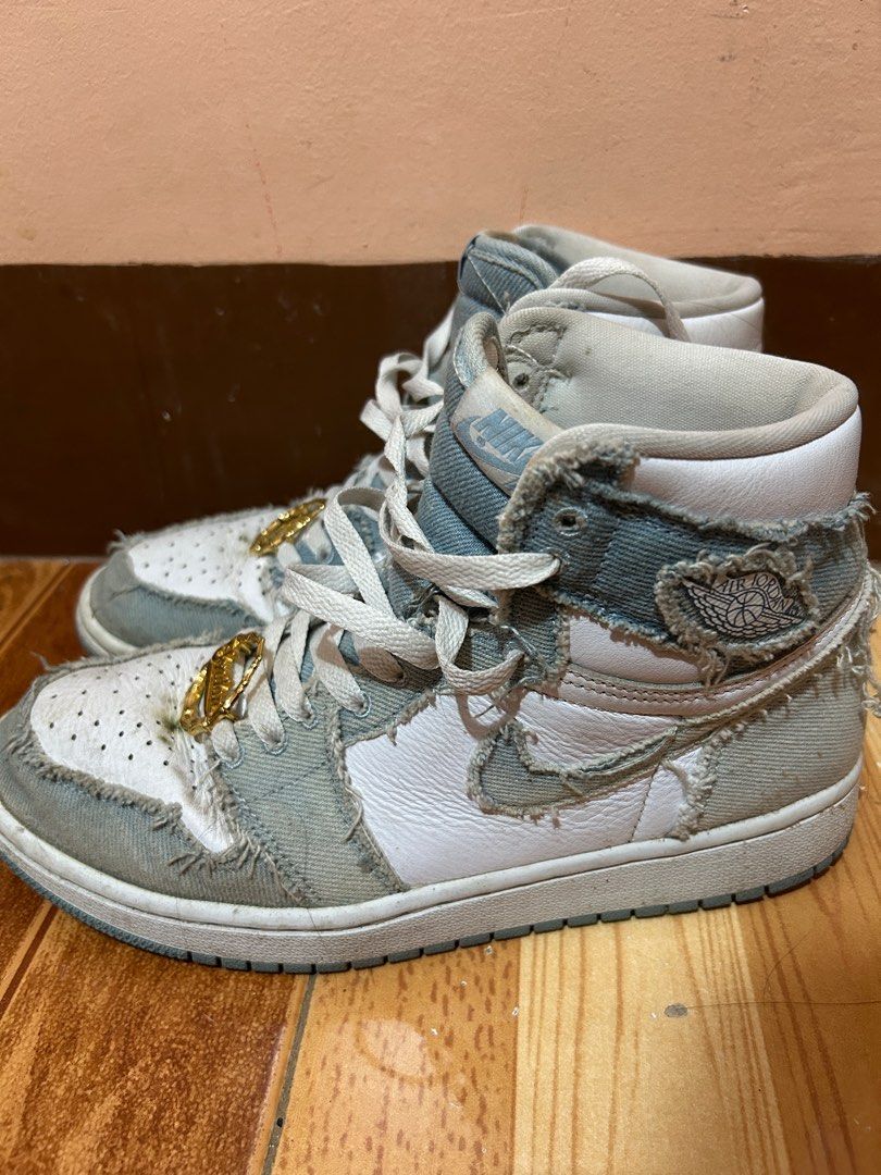 Nike Air Jordan 1 High Denim (Category: Sneakers) located in San Leonardo. Submitted by ur_chai (Listing ID 1399121026, Image 2). Description: - Air Jordan 1 High sneakers - Denim design with white and blue accents - High-top silhouette - Nike Air logo on the tongue - Gold-colored Jordan charms on laces - Unique, worn denim aesthetic Bought for 11k Issue: heavily used, no box.