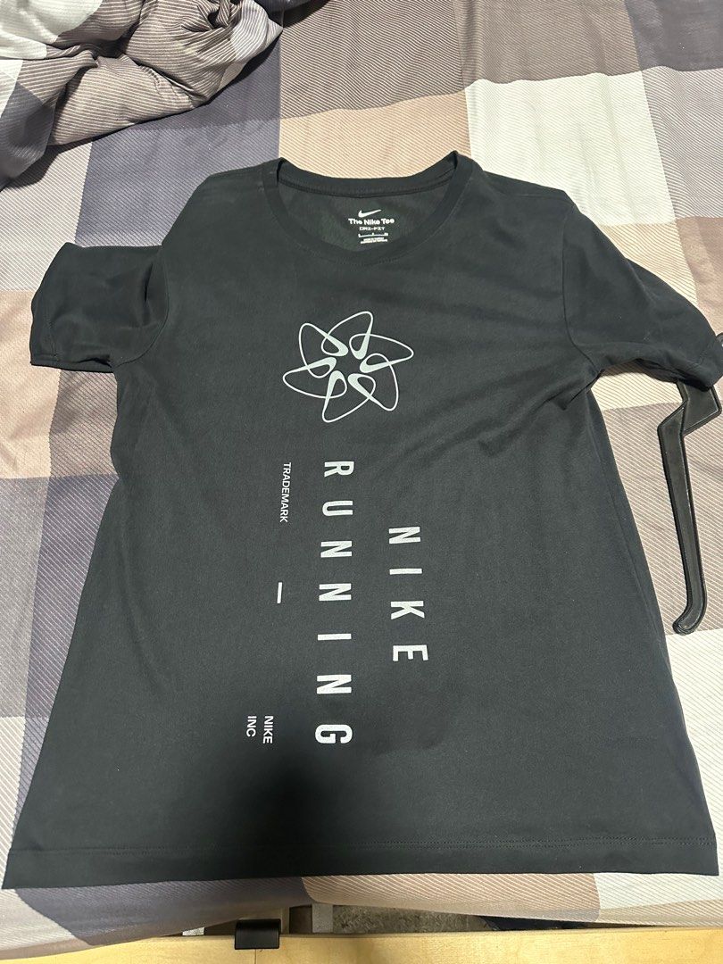 Nike Running Tee (Category: Tshirts & Polo Shirts ) located in Quezon City. Submitted by jaypee0 (Listing ID 1399136031, Image 1). Description: - Black Nike running t-shirt - White Nike logo on upper chest - "RUNNING" printed vertically - Crew neck - Short sleeves - Nike logo on neck.