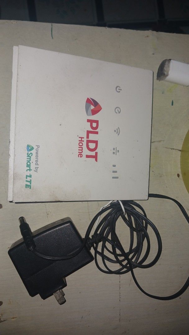 PLDT Home Powered by Smart LTE Router (Category: Networking) located in Manila. Submitted by marcas022798212 (Listing ID 1399172723, Image 2). Description: - PLDT Home router - Powered by Smart LTE - Includes router and power adapter - Features indicator lights and connectivity ports - Device information sticker at the back - In good working condition.