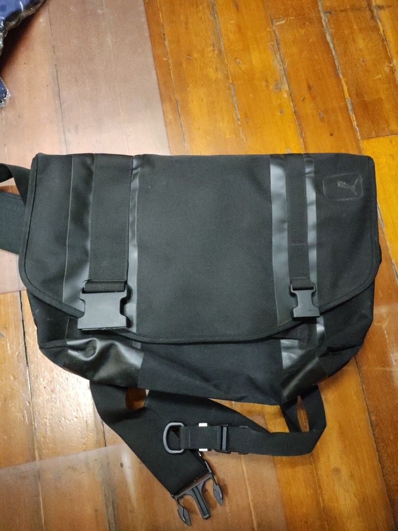 Puma Black Messenger Bag with Buckle Closure (Category: Luxury Bags & Wallets) located in Manila. Submitted by seepeeaylohyer (Listing ID 1399113291, Image 1). Description: -Puma Black messenger bag - Adjustable shoulder strap - Secure buckle closures - Reinforced straps for durability - Includes a small strap pouch - Made of durable, possibly water-resistant material - Simple, functional design.