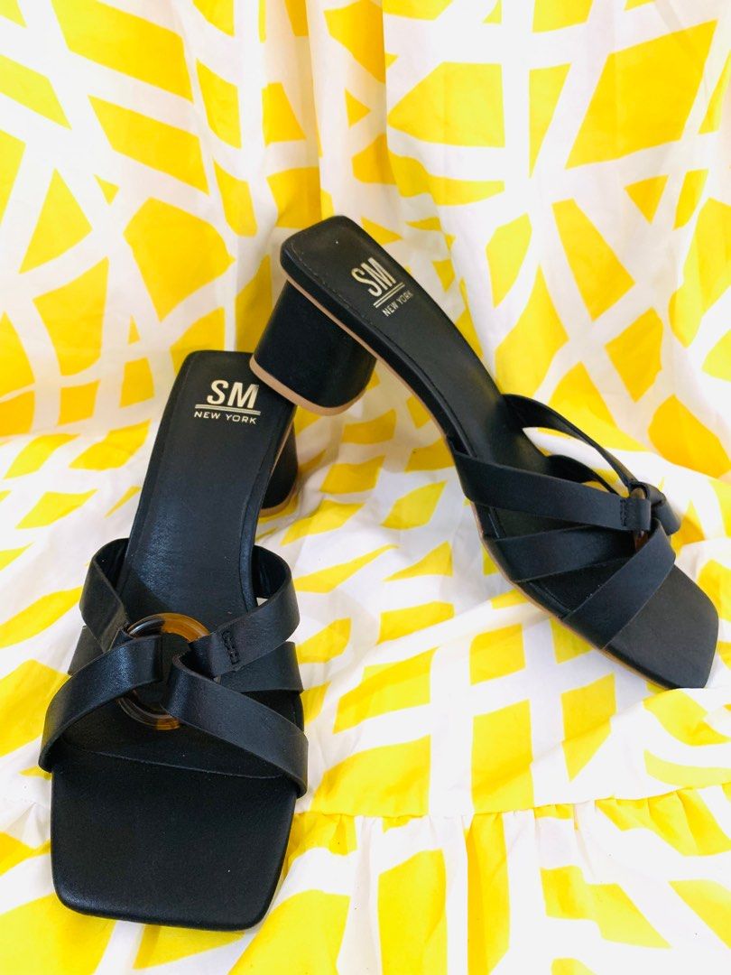 SM New York Black Sandals (Category: Flats & Sandals) located in Sarrat. Submitted by alohas_wagwagan (Listing ID 1399194455, Image 2). Description: - SM New York sandals - Black color - Square toe design - Strap across foot with decorative ring - Block heel - Light brown sole - Size 8.5M.