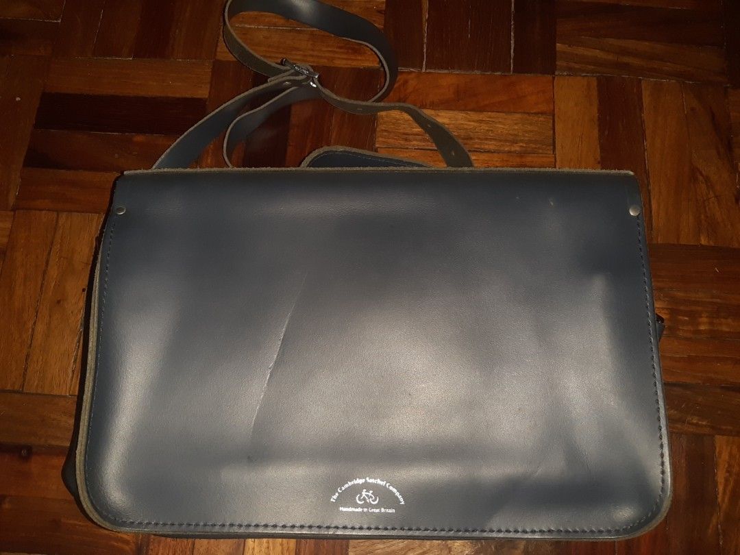 The Cambridge Satchel Company (Category: Luxury Bags & Wallets) located in Davao. Submitted by wonderwallnnipz_91 (Listing ID 1399183685, Image 3). Description: THE CAMBRIDGE SATCHEL COMPANY "BATCHEL" HANDMADE IN GREAT BRITAIN COLOR: NAVY BLUE GOOD CONDITION BUT MAY SMALL FLAWS (SEE PICTURE DETAILS) ACTUAL MEASUREMENTS: 15 INCHES x 9 INCHES x 4 INCHES (expandable) Market price : 17k plus P5000 plus SF Location: Davao City Contact no. 09312178260.