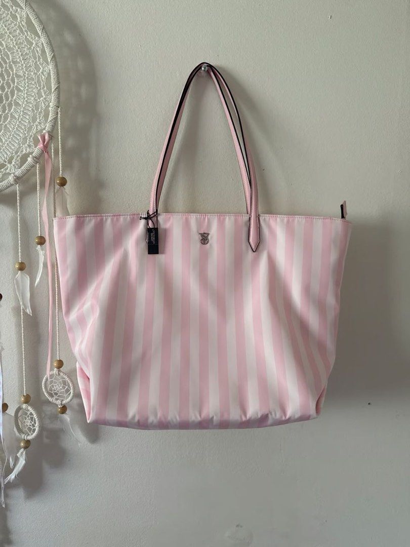 Victoria's Secret Pink Stripe Tote Bag (Category: Tote Bags) located in Kuala Lumpur. Submitted by Bungamelati (Listing ID 1399050255, Image 1). Description: - Brand new Victoria's Secret tote bag - Features a stylish pink and white stripe design - Equipped with two handles for easy carrying - Secure zipper closure - Adorned with a small Victoria's Secret logo - Comes with original tag attached.