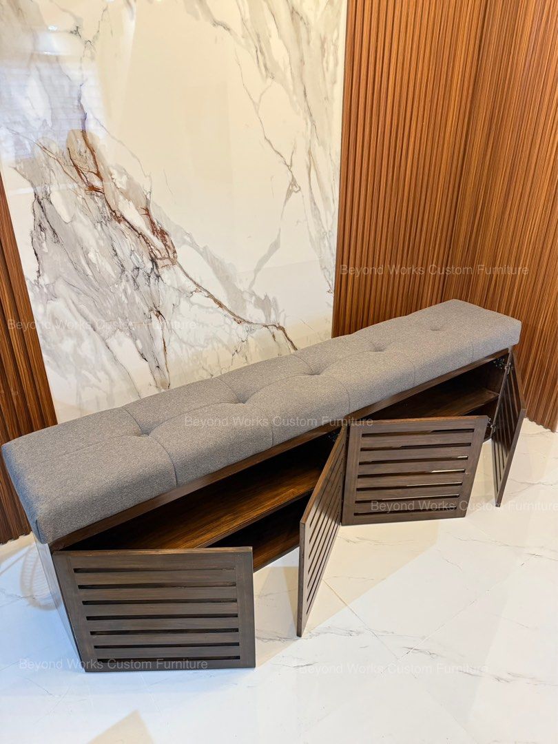 Wooden Shoe Bench with Storage (Category: Shelves, Cabinets & Racks) located in Manila. Submitted by jennyromulo (Listing ID 1399179662, Image 1). Description: - Wooden shoe bench with storage. - Padded, button-tufted gray seat. - Dark wood finish. - Slatted door fronts. - Ideal for entryways or bedrooms. - Provides seating and shoe organization..