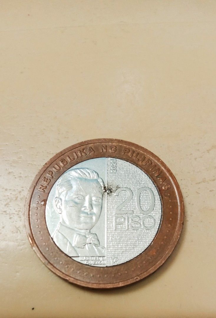 20 Peso 2020 NGC Philippine Coin with Error (Category: Currency) located in Candon. Submitted by sniper_25 (Listing ID 1395930181, Image 3). Description: - 20 Peso NGC coin from the Philippines - Year: 2020 - Features a minting error (extra metal) - Obverse: Manuel Quezon - Reverse: Sampaguita flower Denomination: It is the highest denomination coin of the Philippine peso. Issuance: Launched in December 2019, it is part of the Bangko Sentral ng P