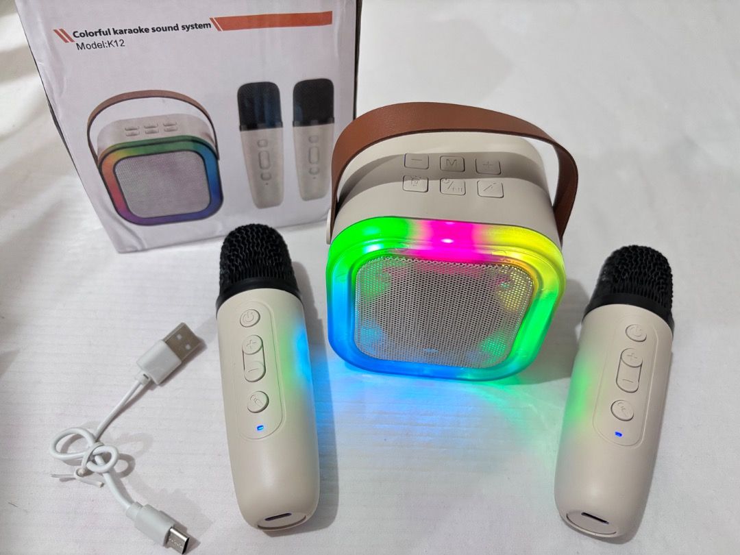 Bluetooth Speaker with 2 Microphones K12 Mini Karaoke (Category: Soundbars, Speakers & Amplifiers) located in Manila. Submitted by 02hamako (Listing ID 1396031557, Image 1). Description: -Bluetooth Speaker with 2 Microphones K12 Mini Karaoke - Speaker features: - Colorful LED lights - Portable with a handle - Multiple input options: AUX, USB, TF card - Microphones with control buttons - Comes with a charging cable Beige color. Never used. All are