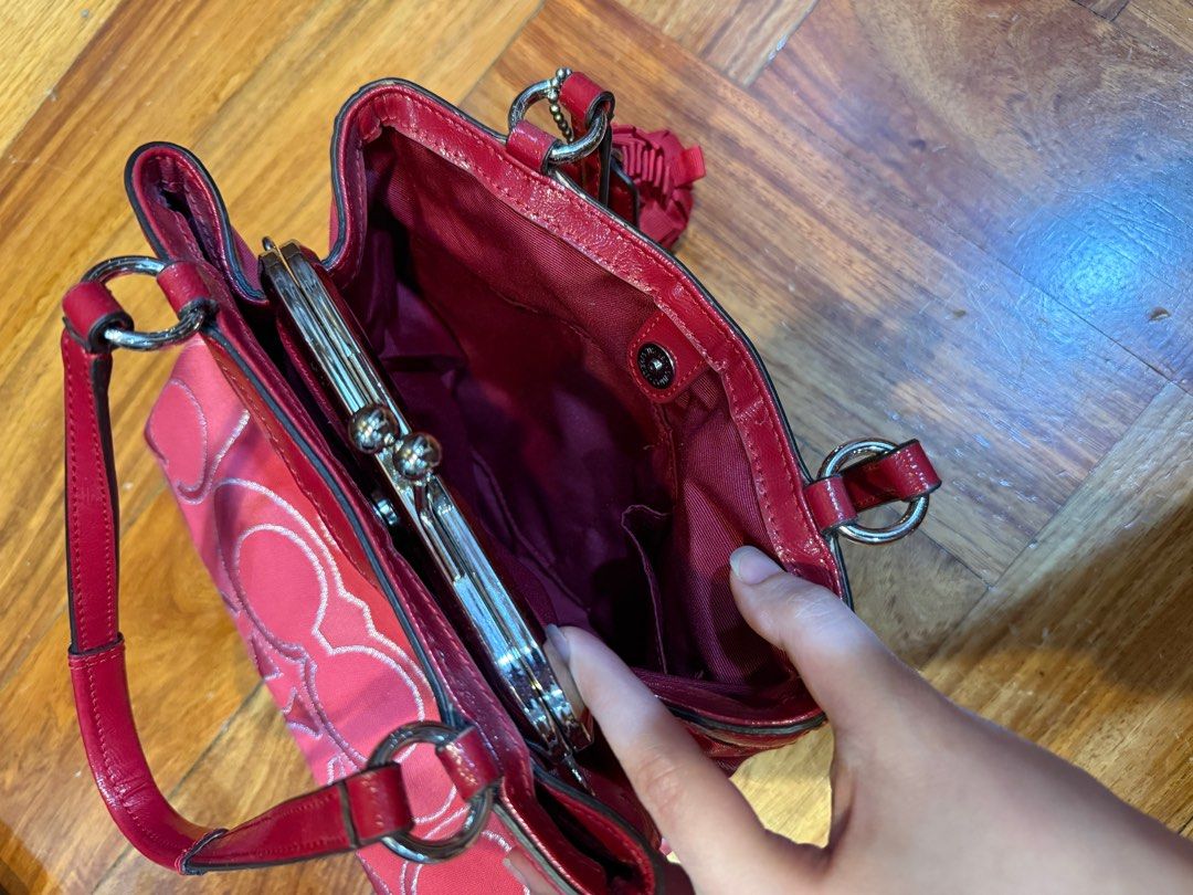 COACH Red Signature Canvas Bag (Category: Luxury Bags & Wallets) located in Quezon City. Submitted by michaelacd (Listing ID 1395988541, Image 3). Description: COACH Red Signature Canvas Bag - can be worn on the shoulder - used once lang sa house. still in great condition - it actually comes with a strap but since matagal na store it became a bit sticky so may tuklap in some parts of the sides. (Dm me for pics) if the condition of the strap is ok