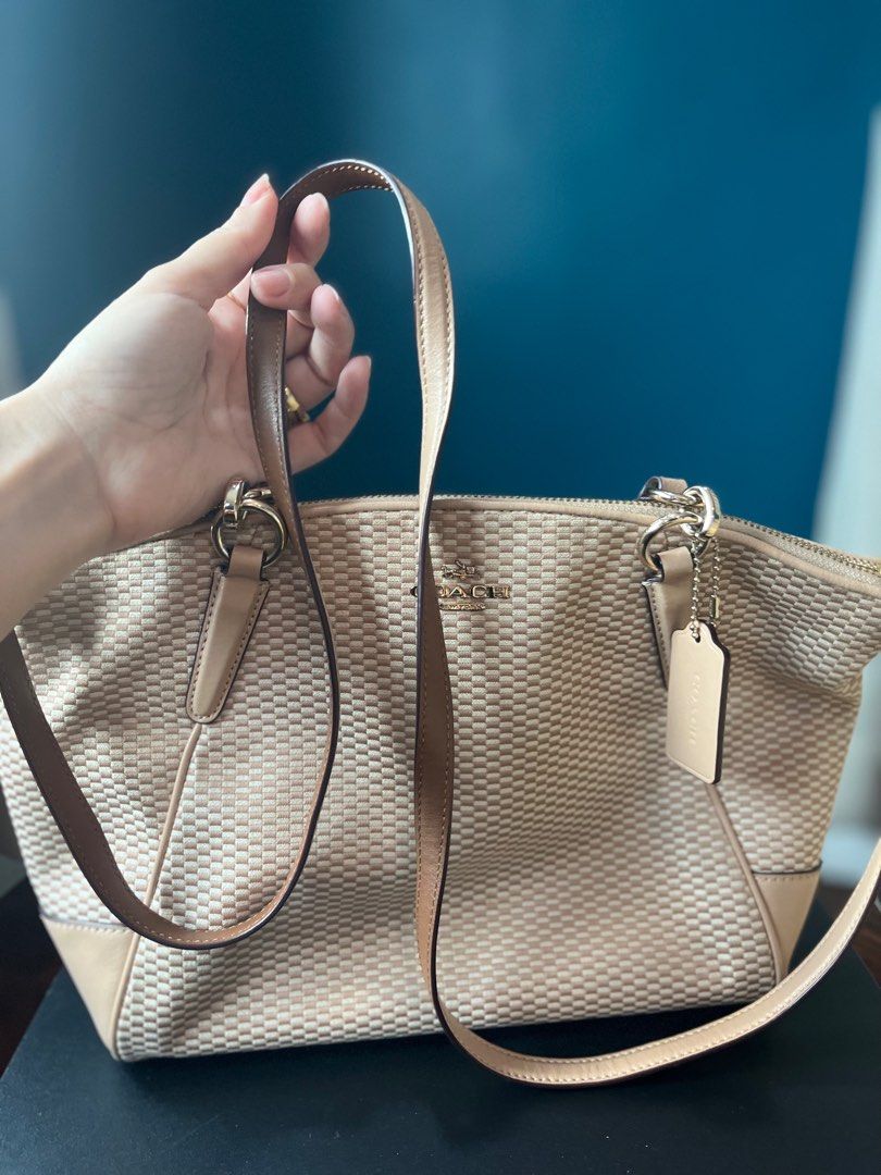 Coach Woven Handbag with Shoulder Strap (Category: Luxury Bags & Wallets) located in Manila. Submitted by nannro (Listing ID 1395969275, Image 1). Description: - Coach handbag with woven design - Top zipper closure - Detachable shoulder strap - Includes Coach hang tag - Light brown color - Interior with multiple compartments and Coach label - Minor marks on the exterior.