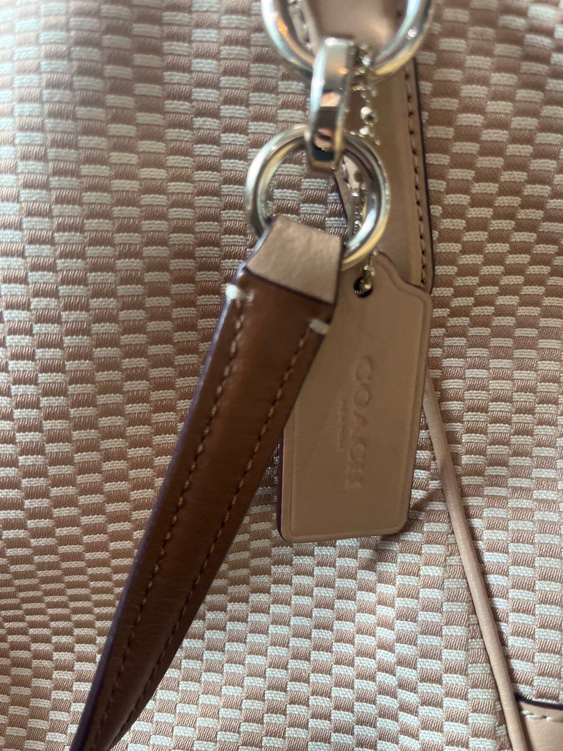 Coach Woven Handbag with Shoulder Strap (Category: Luxury Bags & Wallets) located in Manila. Submitted by nannro (Listing ID 1395969275, Image 3). Description: - Coach handbag with woven design - Top zipper closure - Detachable shoulder strap - Includes Coach hang tag - Light brown color - Interior with multiple compartments and Coach label - Minor marks on the exterior.