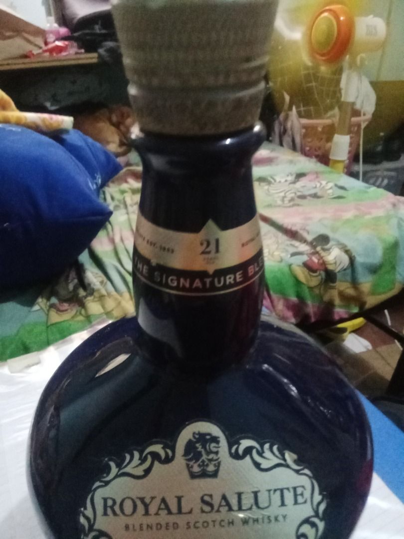 Collectible "EMPTY Royale Salute Bottle"/Collect or Display (Category: Vintage Collectibles) located in Del Monte. Submitted by zurckram777 (Listing ID 1396012521, Image 3). Description: EMPTY "Royale Salute Whisky Bottle" For collection or for display. EMPTY bottle measures 10 inches high by about 4 inches 8n diameter. Front of EMPTY bottle has some exclusive fancy etchings. 1 litre EMPTY bottle. For collection or display. Has some slight signs 