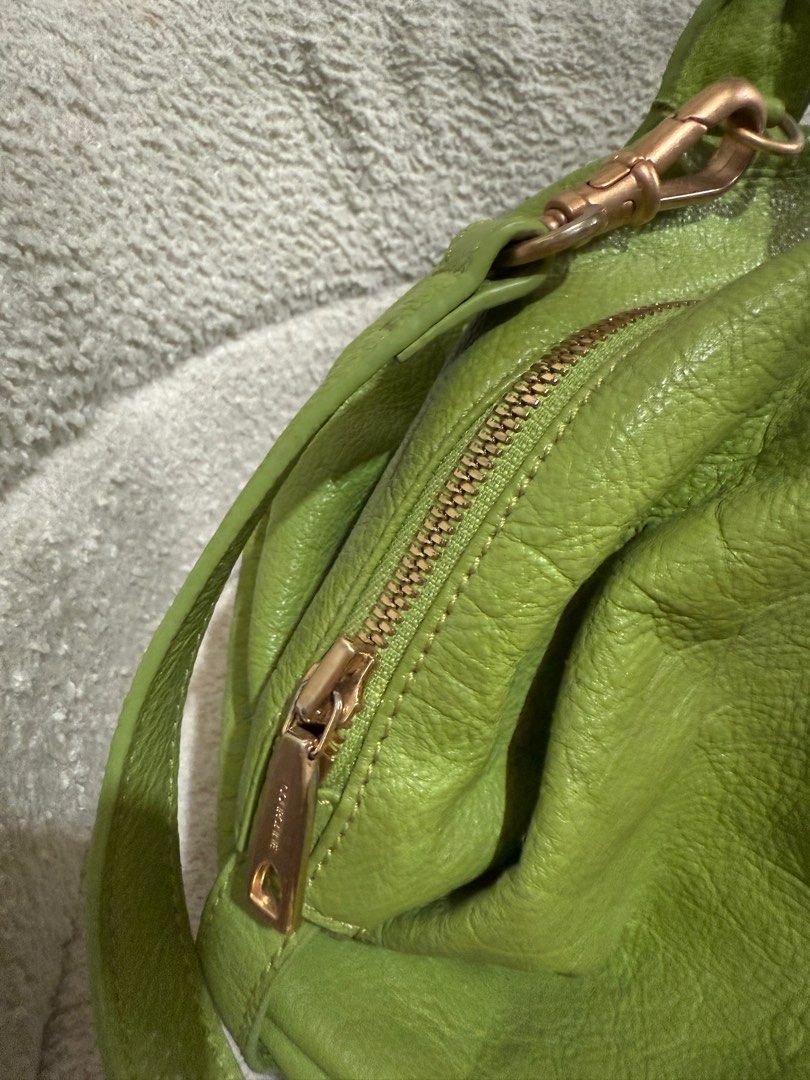 Couronne Green Leather two way bag (Category: Luxury Bags & Wallets) located in Consolacion. Submitted by mrshoarderrr (Listing ID 1396086590, Image 3). Description: - Couronne green leather handbag - Top handle and detachable shoulder strap - Secure zip closure - Elegant gold-tone hardware - Includes Couronne logo tag and front metal plate - Structured shape with textured leather exterior - Light beige interior lining.