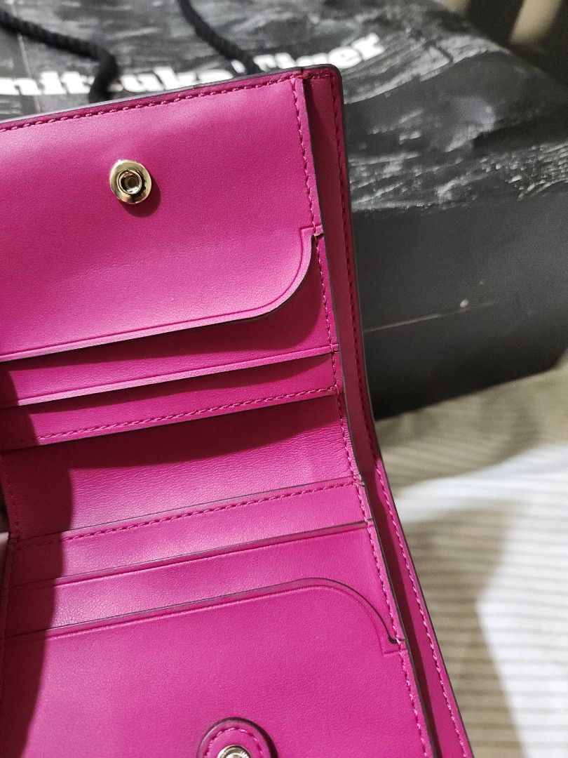 Kate Spade New York Wallet (Category: Wallets & Card holders) located in Santa Rosa. Submitted by huichita (Listing ID 1396064437, Image 3). Description: - Authentic Kate Spade wallet - Color: Vibrant Pink - Features: - Multiple card slots - Zippered compartment - Snap closure - Interior: Pink with Kate Spade logo - Exterior: Kate Spade New York branding in gold - Includes original box.