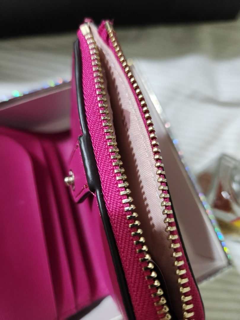Kate Spade New York Wallet (Category: Wallets & Card holders) located in Santa Rosa. Submitted by huichita (Listing ID 1396064437, Image 2). Description: - Authentic Kate Spade wallet - Color: Vibrant Pink - Features: - Multiple card slots - Zippered compartment - Snap closure - Interior: Pink with Kate Spade logo - Exterior: Kate Spade New York branding in gold - Includes original box.