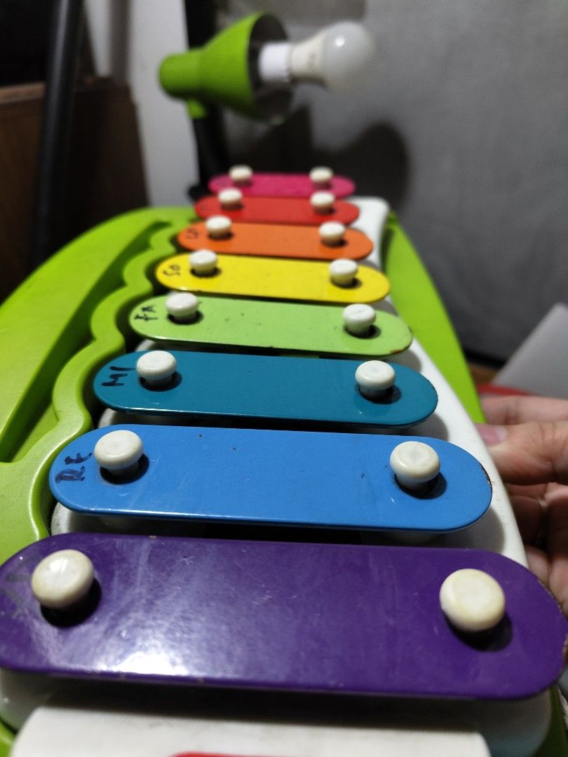 Little Tikes Xylophone (Category: Educational & Learning Toys) located in Makati City. Submitted by rontagz (Listing ID 1396003521, Image 2). Description: Colorful Little Tikes xylophone with a green handle. It features seven rainbow-colored keys with white pegs. The xylophone has a blue string attached. The keys are labeled with musical notes. It is a great musical toy for kids..