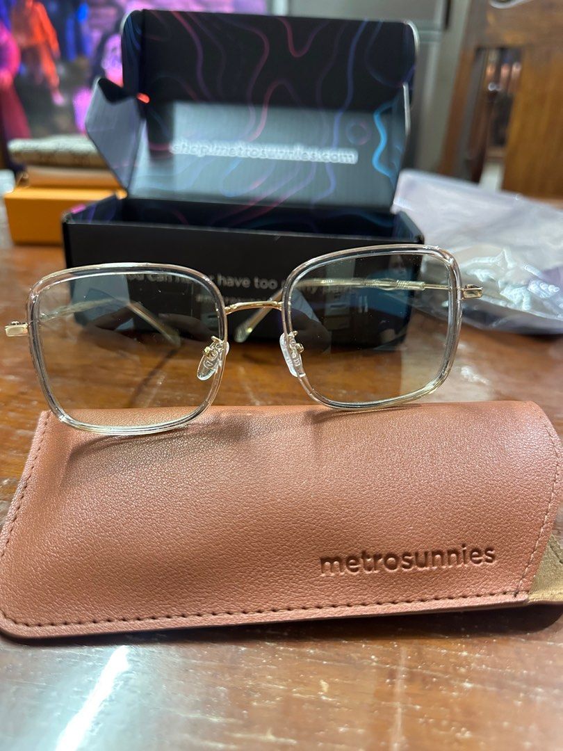 MetroSunnies Eyeglasses (Category: Sunglasses & Eyewear) located in Makati City. Submitted by prelovedkayy (Listing ID 1396082842, Image 2). Description: - MetroSunnies eyeglasses - Gold frame - Clear lenses - Includes brown case with MetroSunnies logo - Comes with original box - Perfect for everyday style.