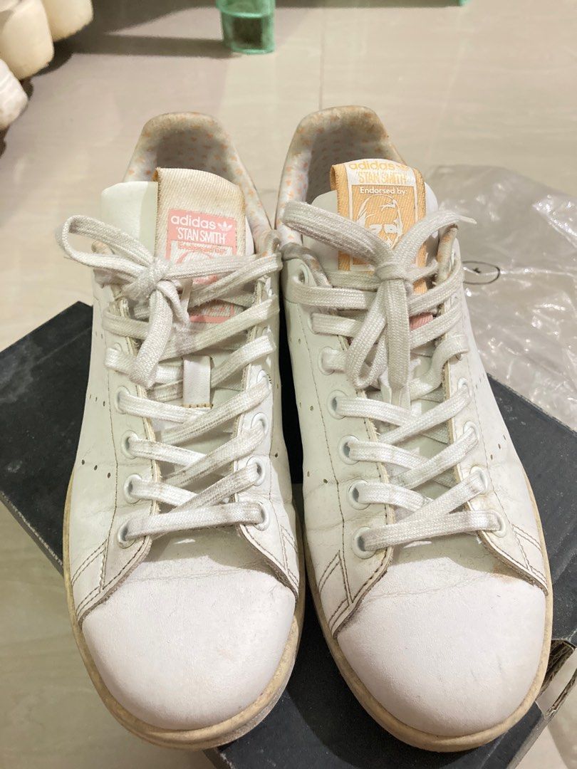 Original Adidas Stan Smith White Sneakers (Category: Sneakers) located in Binan City. Submitted by _elleinad (Listing ID 1395928706, Image 1). Description: - Adidas Stan Smith sneakers - White with pink and yellow accents - Stan Smith logo on heel - Size: US 5.5, UK 5, FR 38, JP 240, CHN 235 - Made in India No box. Needs cleaning.
