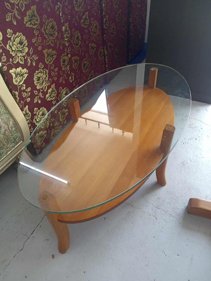 Oval Glass Top Coffee Table (Category: Tables & Sets) located in Manila. Submitted by coolwhale-0343 (Listing ID 1395954294, Image 2). Description: - Oval coffee table - Clear glass top - Light-colored wooden base - Unique curved leg design - Stylish and functional - Perfect for living rooms and lounges.