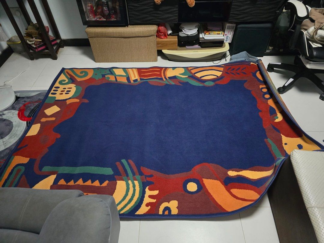 Patterned Rug (Category: Carpets & Mats) located in Singapore. Submitted by samziesss (Listing ID 1392808903, Image 1). Description: - Patterned rug with a blue border - Rolled up and secured with a rubber band - Easy to transport - Adds a touch of color to any space Dimensions: 2 x 2.5m RFS: Too big for our house and we have troubles washing it due to the sheer size.