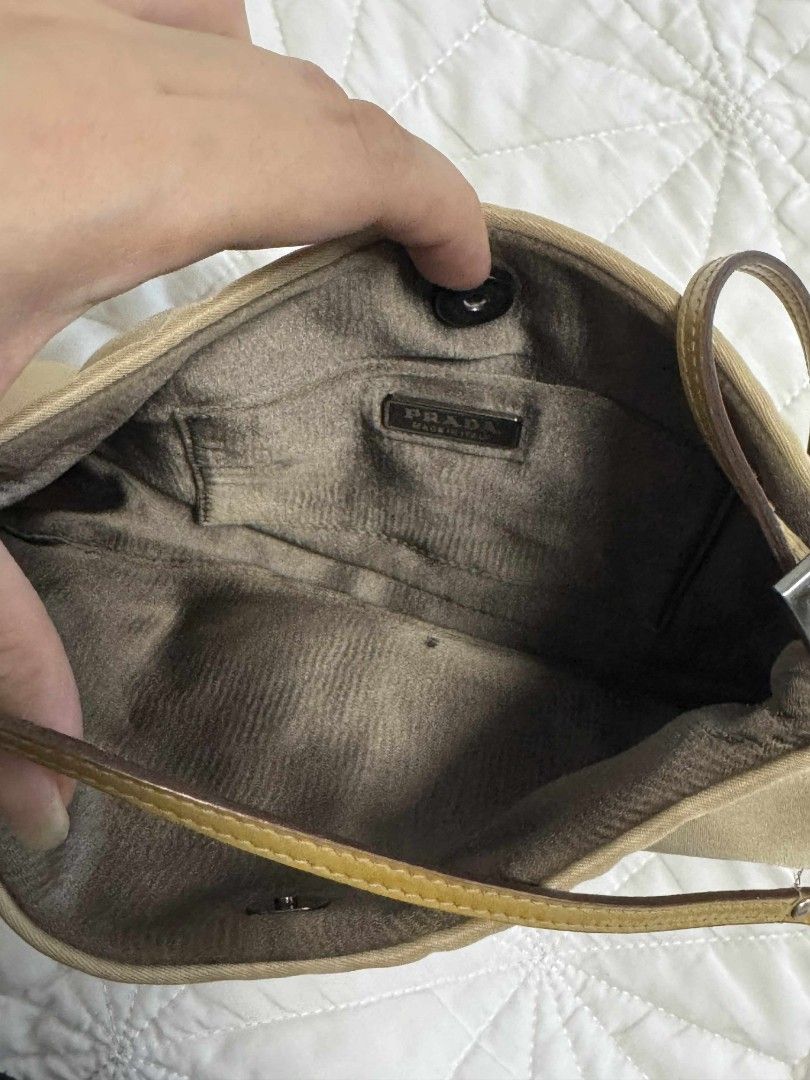Prada Shoulder Bag (Category: Luxury Bags & Wallets) located in Quezon City. Submitted by thrift.and.find (Listing ID 1395939594, Image 3). Description: - Authentic Prada shoulder bag - Color: Beige - Material: Nylon - Strap: Black and beige leather - Closure: Snap - Features: Prada logo, Prada interior label rfs: not into lux bag binigay na kase ni mama sakin mga collections niya inclusion: bag with replacement dustbag slight nego.