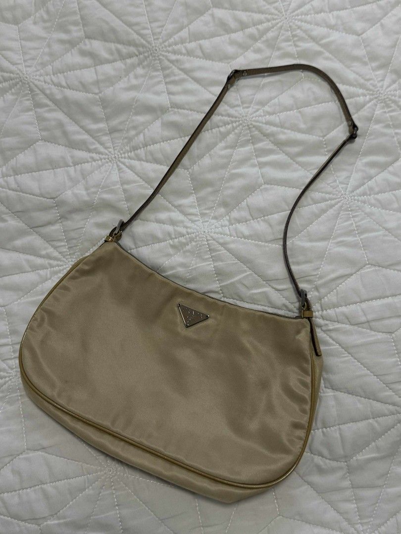 Prada Shoulder Bag (Category: Luxury Bags & Wallets) located in Quezon City. Submitted by thrift.and.find (Listing ID 1395939594, Image 1). Description: - Authentic Prada shoulder bag - Color: Beige - Material: Nylon - Strap: Black and beige leather - Closure: Snap - Features: Prada logo, Prada interior label rfs: not into lux bag binigay na kase ni mama sakin mga collections niya inclusion: bag with replacement dustbag slight nego.