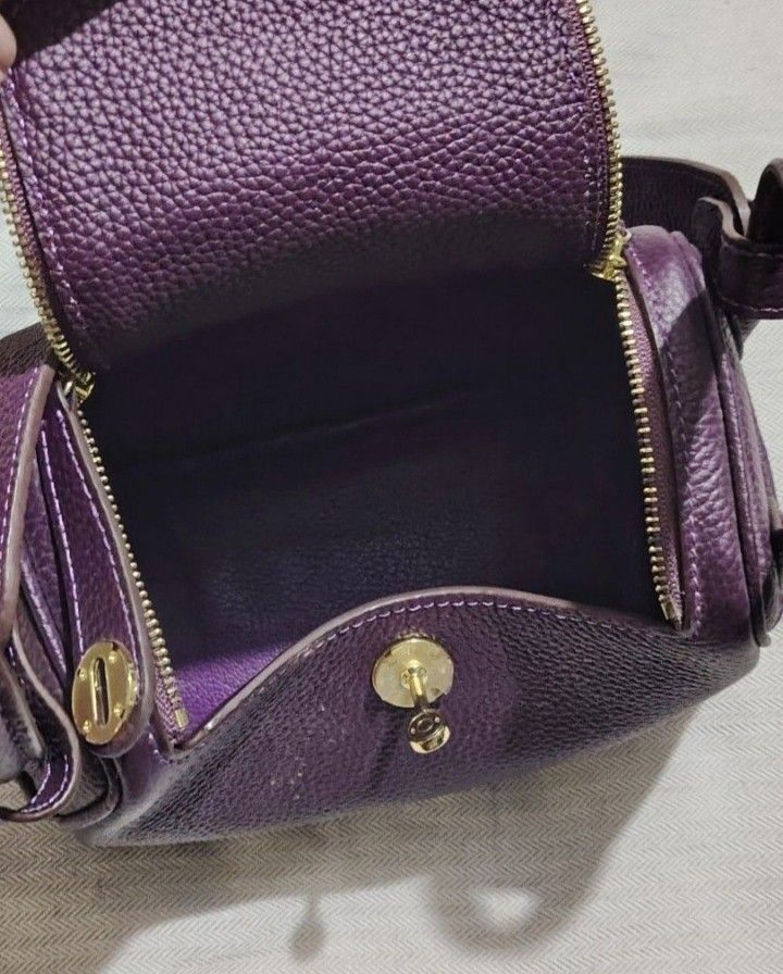 Purple Leather Handbag (Category: Luxury Bags & Wallets) located in Dipolog. Submitted by bentley03 (Listing ID 1395925073, Image 1). Description: - Luxurious purple leather exterior - Gold-toned zipper and hardware - Matching purple interior - Structured shape with top handle - Secure flap closure - High-quality construction with visible stitching.