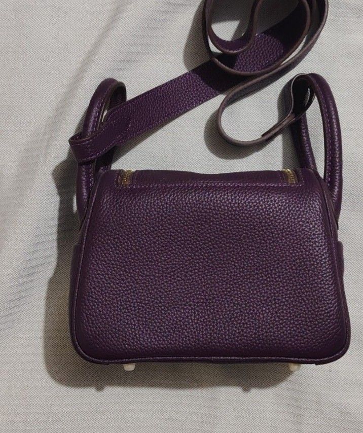 Purple Leather Handbag (Category: Luxury Bags & Wallets) located in Dipolog. Submitted by bentley03 (Listing ID 1395925073, Image 3). Description: - Luxurious purple leather exterior - Gold-toned zipper and hardware - Matching purple interior - Structured shape with top handle - Secure flap closure - High-quality construction with visible stitching.