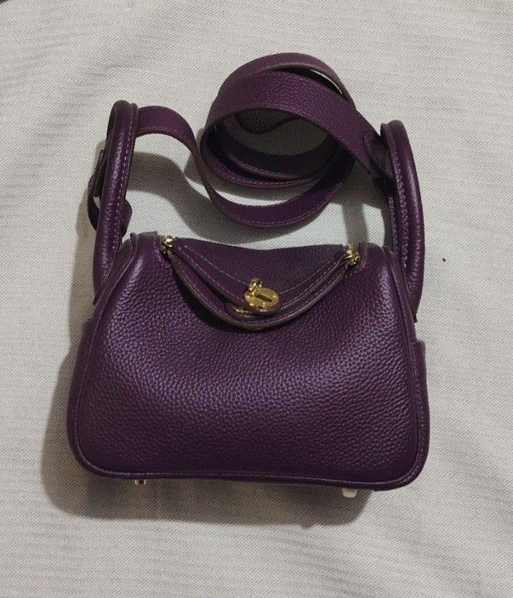 Purple Leather Handbag (Category: Luxury Bags & Wallets) located in Dipolog. Submitted by bentley03 (Listing ID 1395925073, Image 2). Description: - Luxurious purple leather exterior - Gold-toned zipper and hardware - Matching purple interior - Structured shape with top handle - Secure flap closure - High-quality construction with visible stitching.