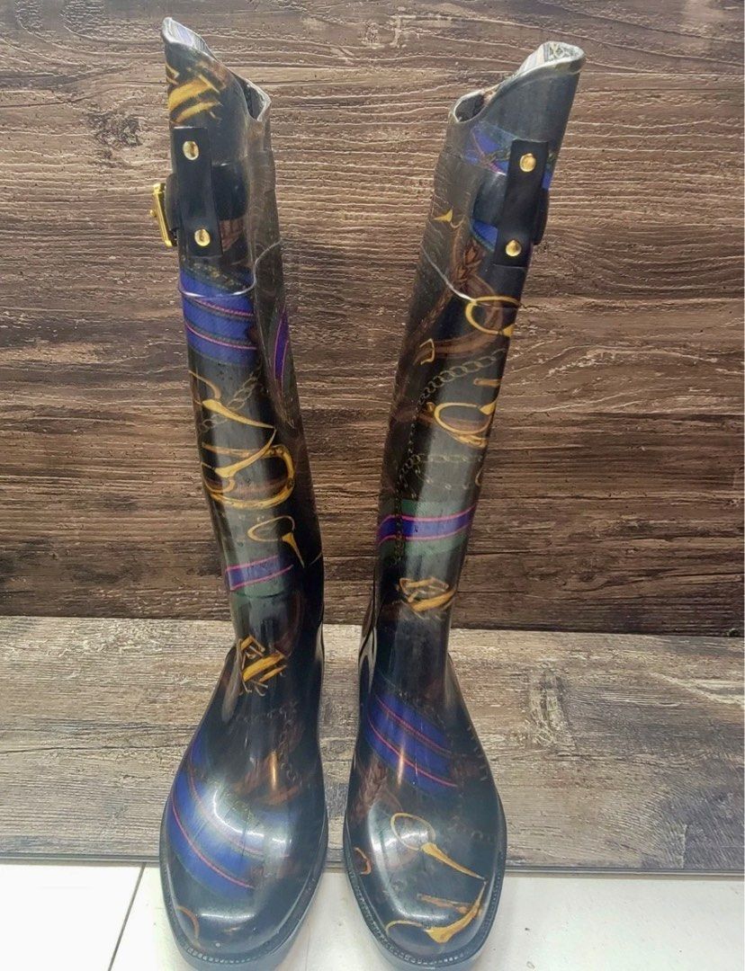 Ralph Lauren Rossalyn II Rain Boots (Category: Boots) located in Las Pinas. Submitted by gwenangels7 (Listing ID 1396044973, Image 2). Description: The Lauren Ralph Lauren Rosalyn II Knee High Rain Boots in Black Gold Rope Chain, size 6, are a stylish and versatile option for women. With an almond toe shape and low block heel, these boots are perfect for casual or workwear occasions. The PVC fabric and waterproof feature make them ideal for all s
