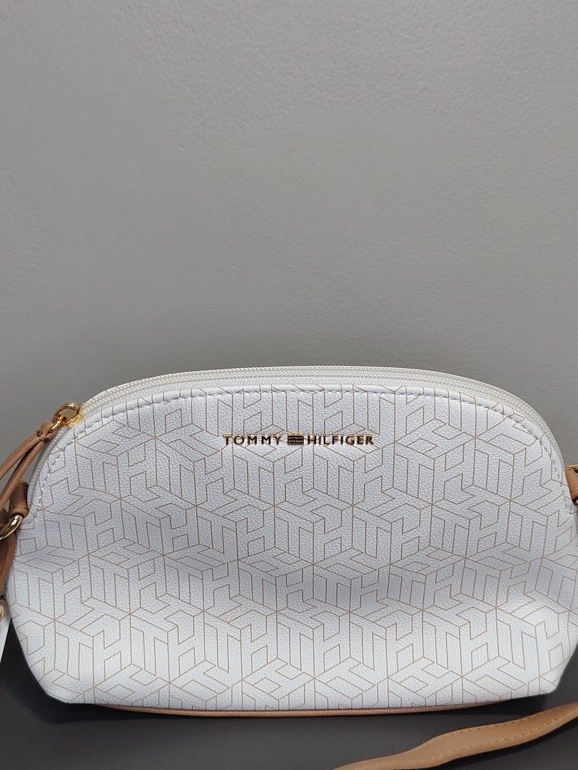 Tommy Hilfiger Crossbody Bag (Category: Luxury Bags & Wallets) located in Las Pinas. Submitted by happinoyshop (Listing ID 1396099865, Image 2). Description: 🫰Stylish and versatile Tommy Hilfiger crossbody bag 👜 Color: White with subtle TH monogram design, tan adjustable strap, gold zipper detail 📏 Perfect size for daily essentials (phone, wallet, keys, makeup, etc.) 👌 Brand new with tag ✅ Authentic Tommy Hilfiger 📍 Las Piñas City |Shipping 