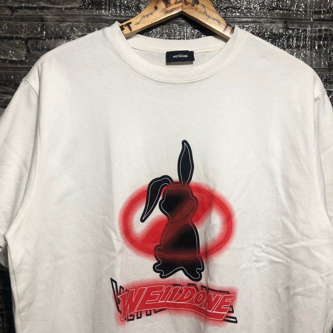 We11done Bunny Graphic T-shirt (Category: Luxury Apparel) located in Manila. Submitted by flex_curation (Listing ID 1396057079, Image 2). Description: DIMES 23x27 550 PESOS ONLY BACOOR CAVITE LOC White We11done T-shirt Features a bunny graphic on the front (black and red) Brand name printed below the graphic Crew neck.