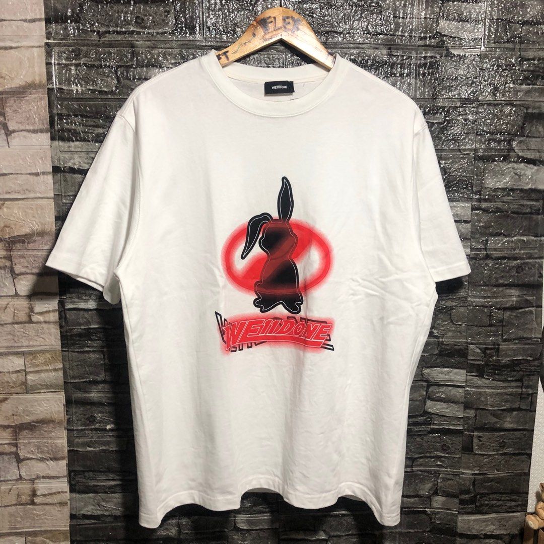 We11done Bunny Graphic T-shirt (Category: Luxury Apparel) located in Manila. Submitted by flex_curation (Listing ID 1396057079, Image 1). Description: DIMES 23x27 550 PESOS ONLY BACOOR CAVITE LOC White We11done T-shirt Features a bunny graphic on the front (black and red) Brand name printed below the graphic Crew neck.