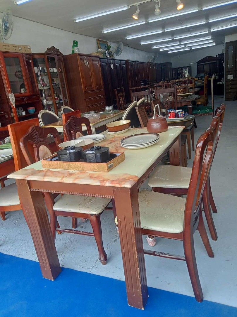 Wooden Dining Table with Chairs (Category: Tables & Sets) located in Manila. Submitted by coolwhale-0343 (Listing ID 1395953877, Image 2). Description: - Wooden dining table with a marble-like top - Includes six matching chairs with cushioned seats - Dark brown finish - Sturdy and well-maintained - Perfect for family meals or entertaining - Classic look.