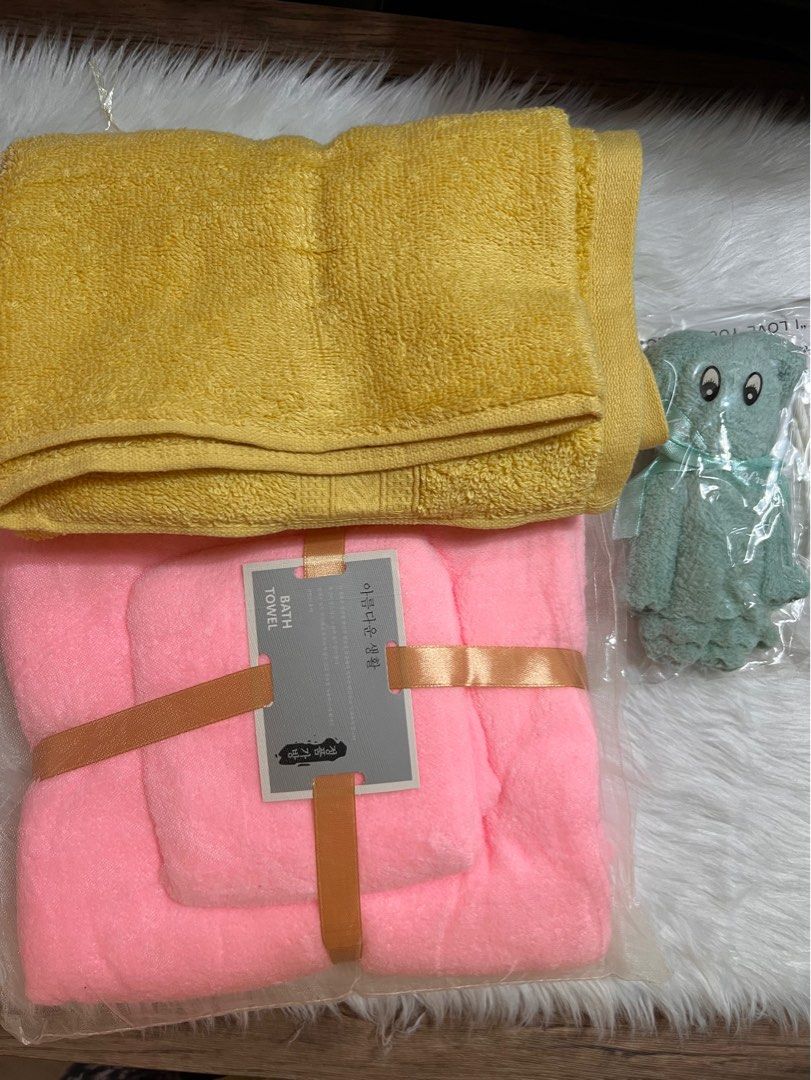 Bath Towel Set with Elephant Washcloth (Category: Bedding & Towels) located in Lubao. Submitted by mioreecollection (Listing ID 1399385579, Image 1). Description: - Pink bath towel set (new, in original packaging with ribbon) - Yellow towel (folded) - Elephant washcloth (sealed in plastic) Perfect for your bathroom or as a gift!.