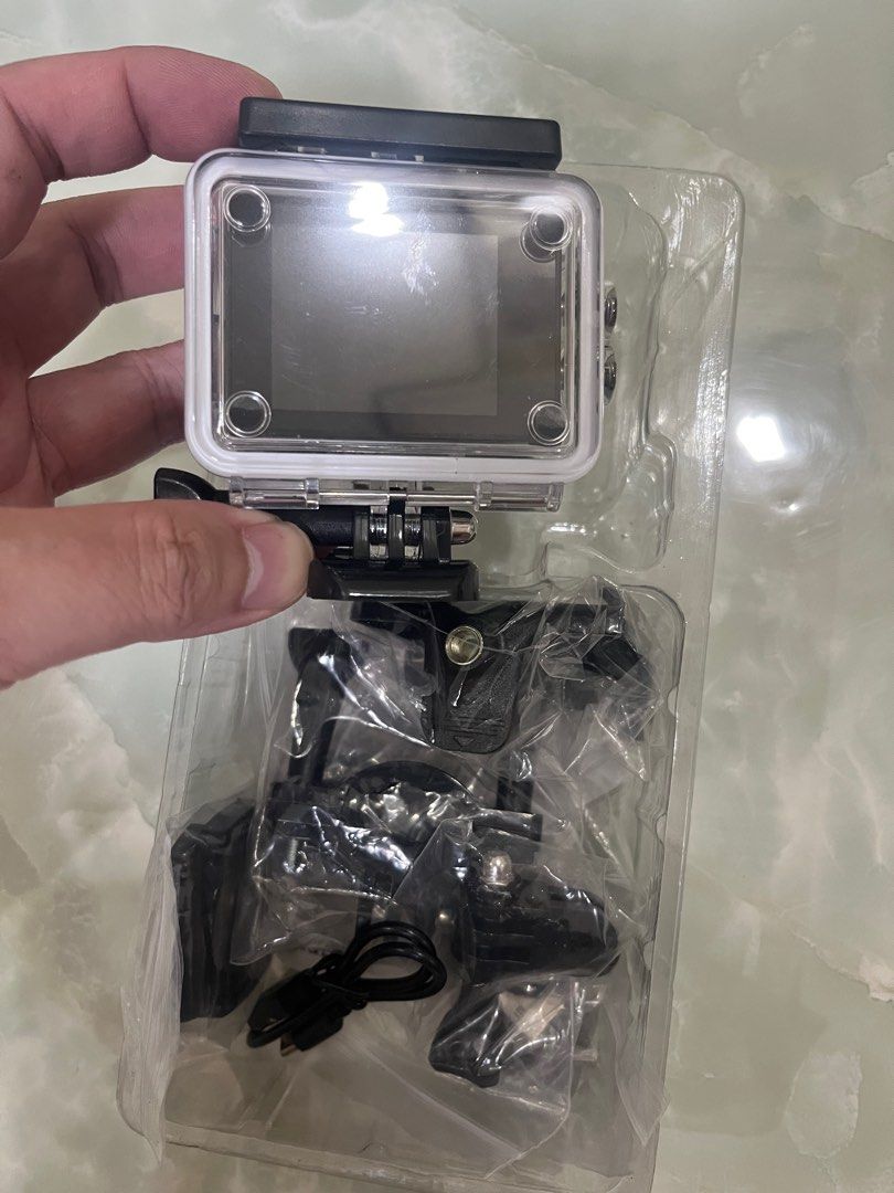 Cherry Mobile Action Camera with Accessories (Category: Cameras) located in Manila. Submitted by ny5skhr4vb08531 (Listing ID 1399269063, Image 2). Description: - Cherry Mobile action camera - Comes with waterproof case - Includes various mounting accessories - Features a front-facing lens and rear screen - Includes charging cable - Brand new, in original packaging.