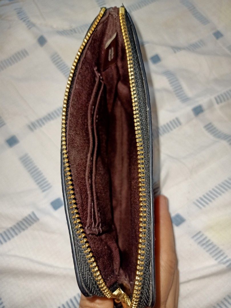 Coach Black Wristlet (Category: Luxury Bags & Wallets) located in Angeles City. Submitted by ejhere (Listing ID 1399380421, Image 3). Description: - Black Coach Wristlet - Embossed Coach logo pattern - Zip-around closure - Wrist strap included - Multiple card slots inside - Gold-toned hardware 🔻COURIER: J&T 🔻SHIPPING FEE TO BE SHOULDERED BY THE BUYER *Estimated min Shipping Fee within Luzon Php58 ‼️FOR SURE BUYER ONLY PLEASE‼️ ❣️LAST PRICE POST